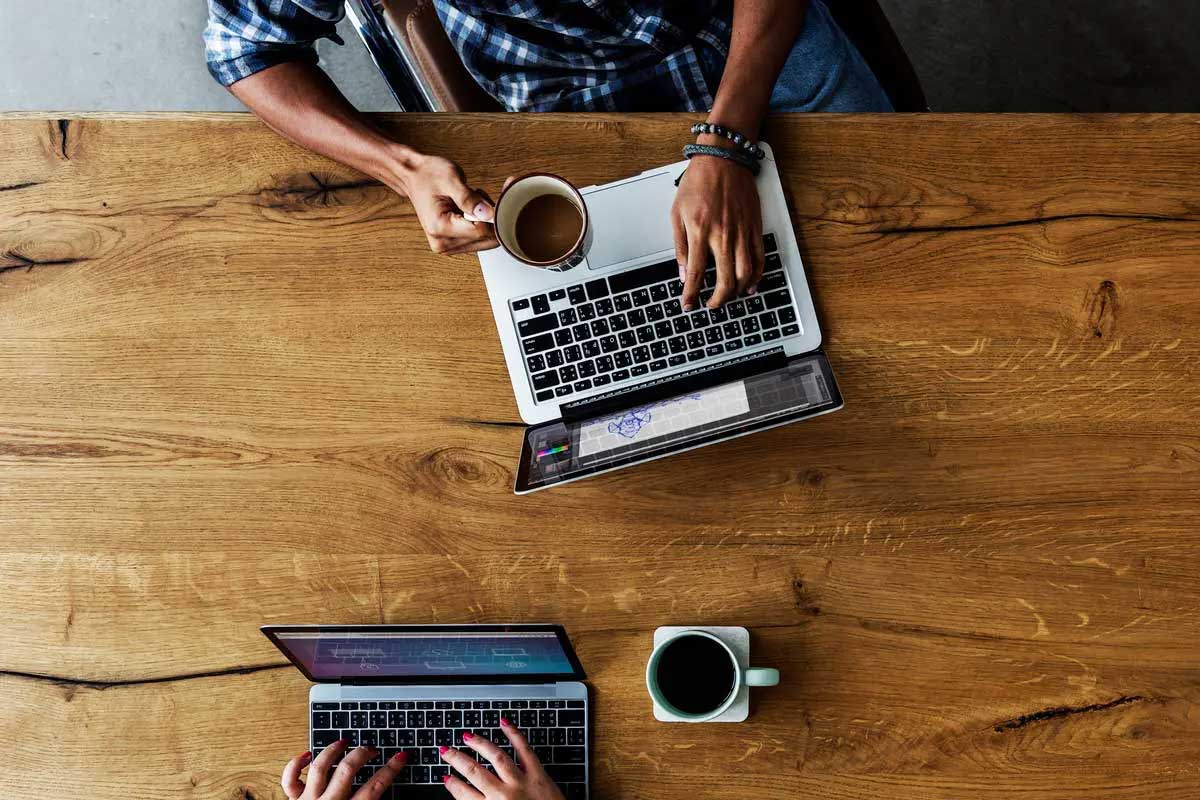 Overhead shot of coffee and laptops